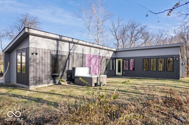 rear view of house with a yard