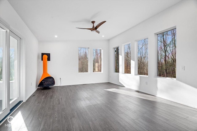 7650 Clarion Dr, Indianapolis, IN 46236 - empty room with wood finished floors, a ceiling fan, a wood stove, and recessed lighting