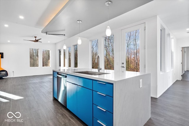 kitchen with stainless steel dishwasher, a healthy amount of sunlight, sink, and an island with sink