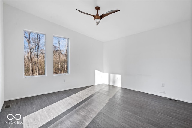 unfurnished room featuring ceiling fan, dark hardwood / wood-style flooring, and vaulted ceiling