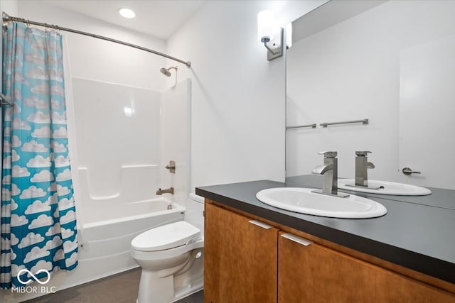 full bathroom featuring toilet, vanity, and shower / tub combo with curtain