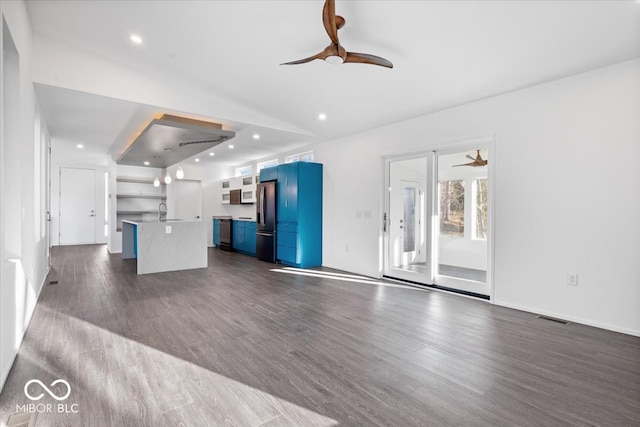 unfurnished living room featuring ceiling fan, sink, and dark hardwood / wood-style floors