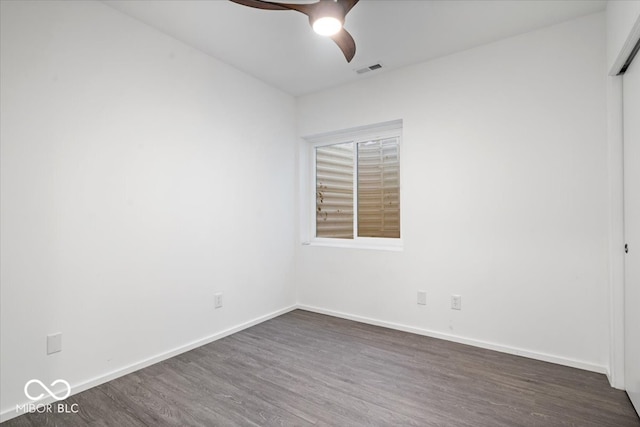 empty room with ceiling fan and dark wood-type flooring