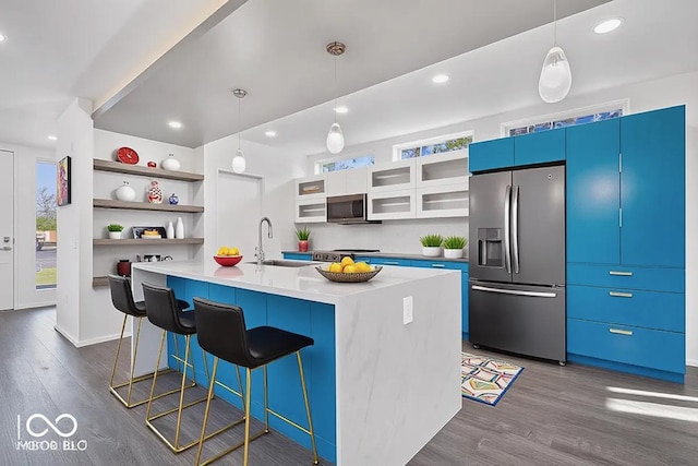 7650 Clarion Dr, Indianapolis, IN 46236 - kitchen with appliances with stainless steel finishes, a sink, dark wood-type flooring, a breakfast bar area, and open shelves