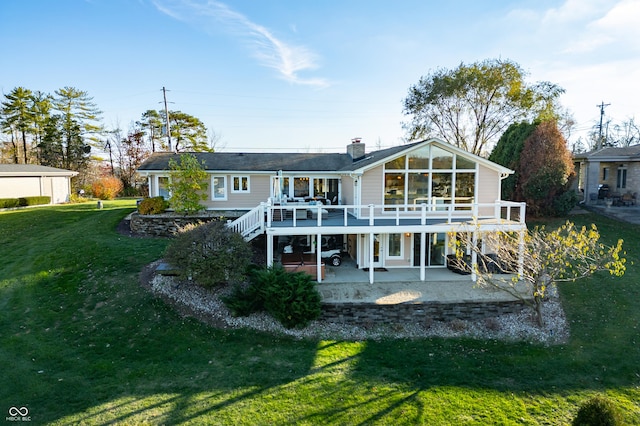 back of property with a yard, a patio, and a deck