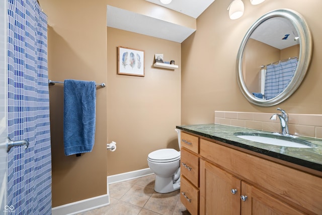 bathroom with tile patterned flooring, vanity, and toilet