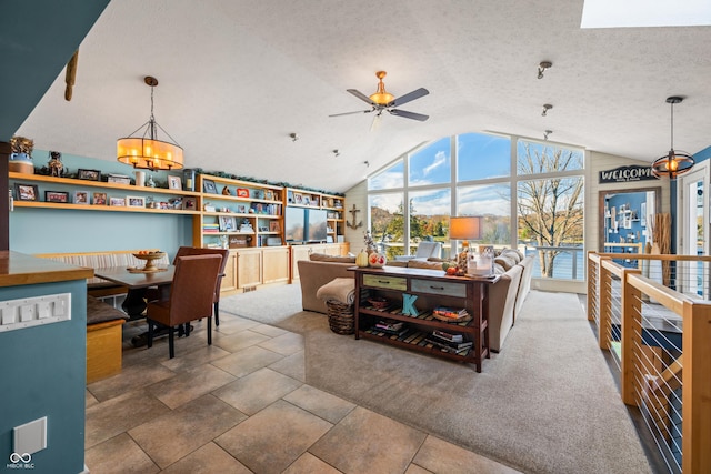 carpeted living room with a textured ceiling, ceiling fan with notable chandelier, and lofted ceiling