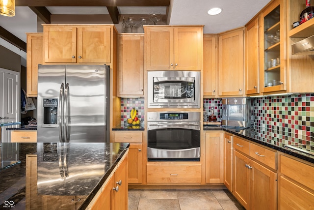 9454 Raintree Dr S, Columbus, IN 47201 - kitchen with stainless steel appliances, decorative backsplash, dark stone counters, glass insert cabinets, and recessed lighting