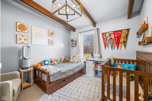 bedroom featuring carpet, beam ceiling, a nursery area, and a notable chandelier