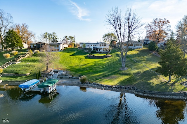 exterior space with a lawn, a dock, and a water view