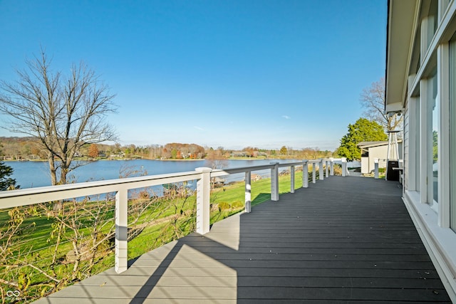 wooden terrace featuring a water view