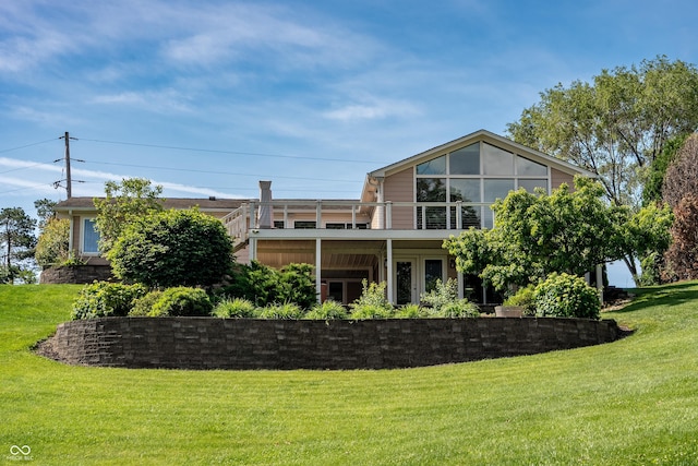 9454 Raintree Dr S, Columbus, IN 47201 - rear view of house with a yard and a balcony