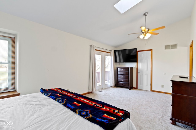 carpeted bedroom with ceiling fan and lofted ceiling with skylight