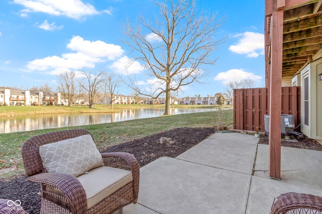 view of patio with a water view and central air condition unit