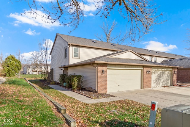 view of home's exterior with a garage and a yard