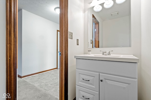 bathroom featuring vanity and a textured ceiling