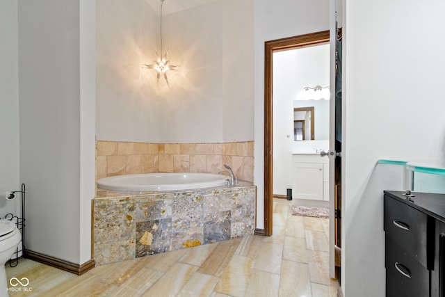 bathroom with tiled bath and vanity