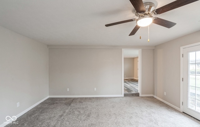 unfurnished room featuring ceiling fan and carpet floors