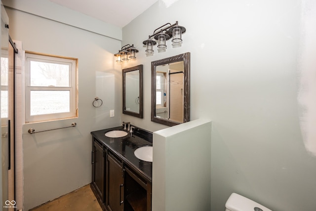 bathroom with vanity, concrete floors, and toilet