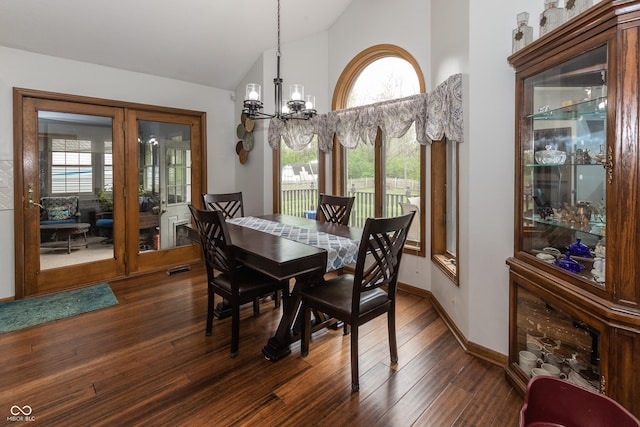 dining room featuring a notable chandelier, dark hardwood / wood-style floors, and vaulted ceiling