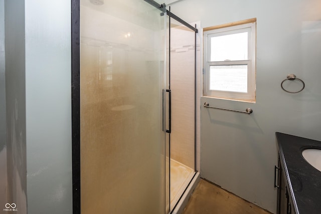 bathroom featuring concrete floors, vanity, and a shower with shower door