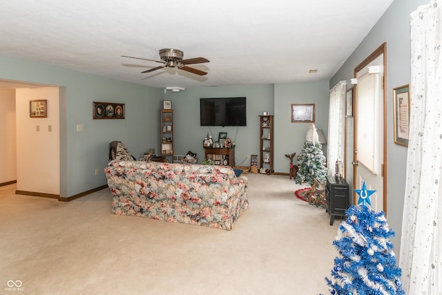 living room with ceiling fan and light colored carpet