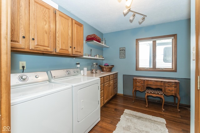 washroom with washer and clothes dryer, cabinets, track lighting, a textured ceiling, and dark hardwood / wood-style flooring