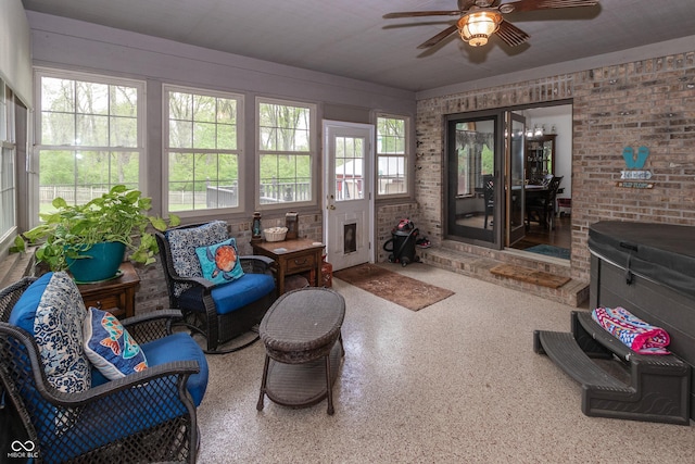 sunroom featuring ceiling fan