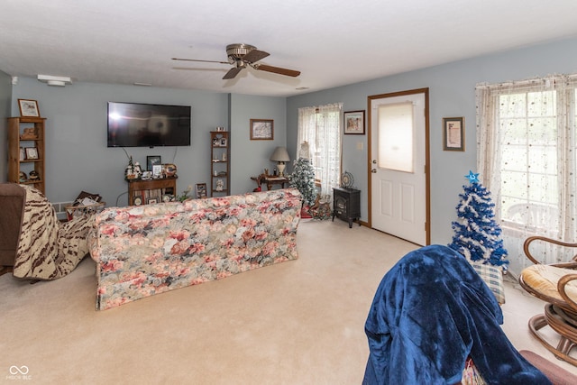 carpeted living room with ceiling fan