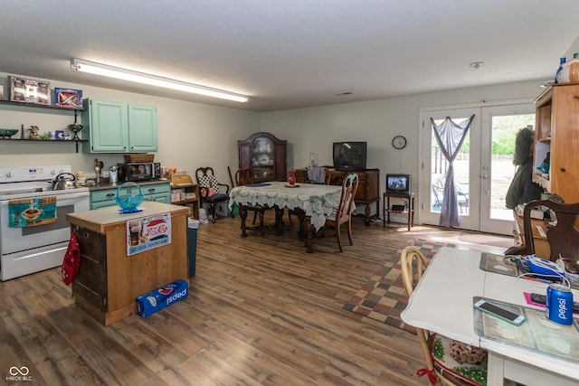 kitchen featuring white range with electric stovetop, green cabinets, french doors, and dark hardwood / wood-style floors