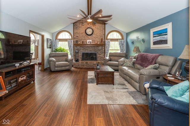 living room with dark hardwood / wood-style floors, a healthy amount of sunlight, and vaulted ceiling