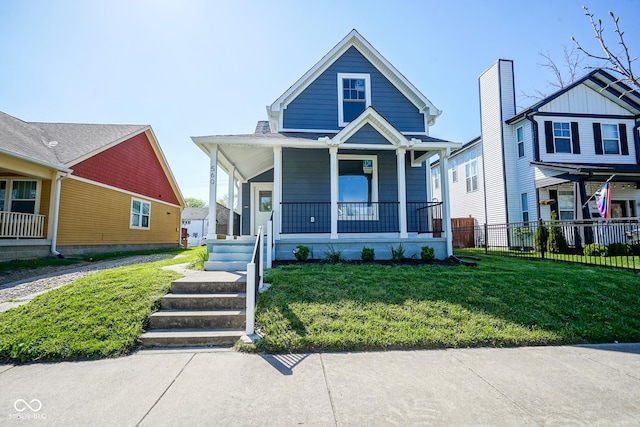 view of front of house with covered porch and a front lawn