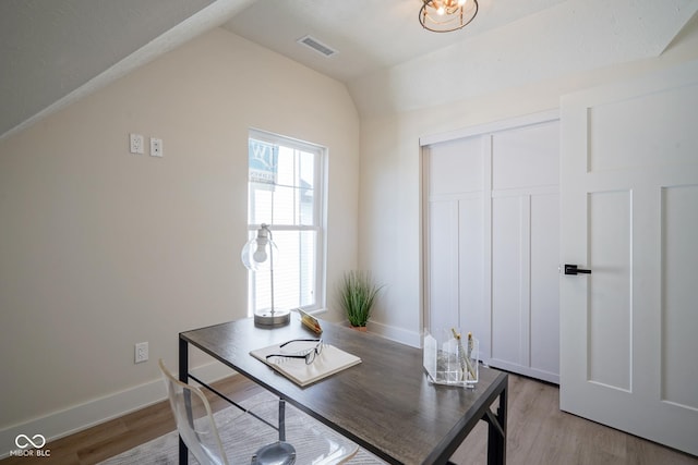 office area featuring vaulted ceiling and light hardwood / wood-style floors