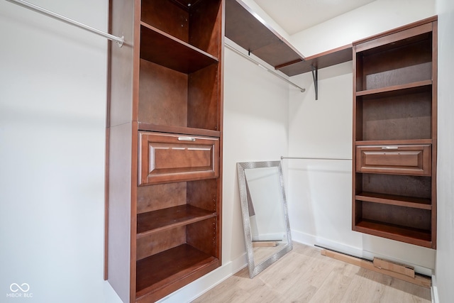 walk in closet featuring light hardwood / wood-style floors