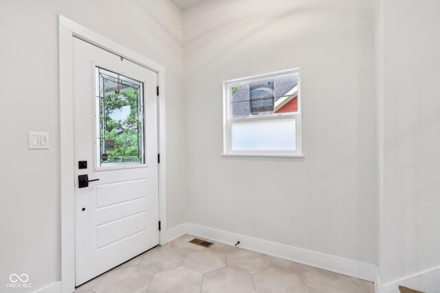 560 Jefferson Ave, Indianapolis, IN 46201 - doorway to outside with baseboards and light tile patterned floors