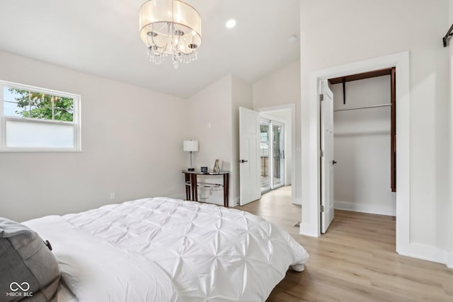 560 Jefferson Ave, Indianapolis, IN 46201 - bedroom featuring light wood finished floors, a chandelier, vaulted ceiling, baseboards, and recessed lighting