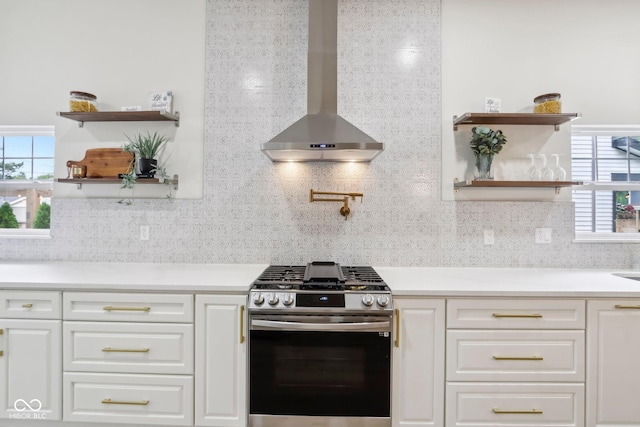 560 Jefferson Ave, Indianapolis, IN 46201 - kitchen featuring gas range, wall chimney range hood, open shelves, and white cabinets