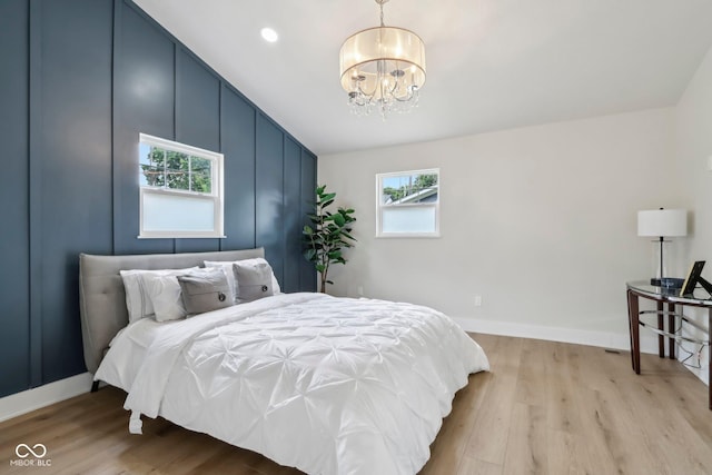 560 Jefferson Ave, Indianapolis, IN 46201 - bedroom with a chandelier, light wood-style flooring, vaulted ceiling, and baseboards