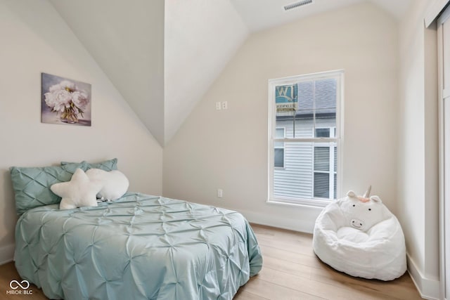 560 Jefferson Ave, Indianapolis, IN 46201 - bedroom with vaulted ceiling, wood finished floors, and baseboards