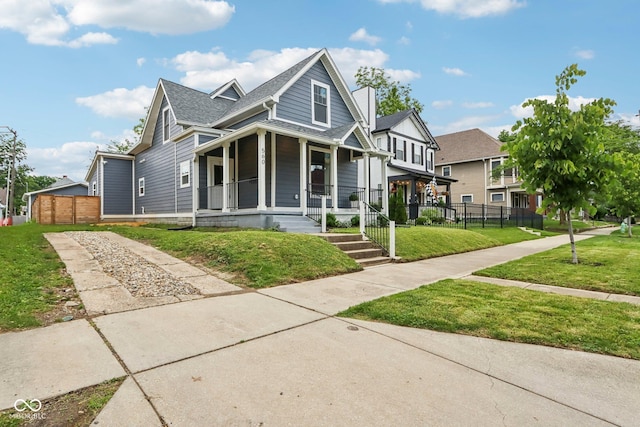 560 Jefferson Ave, Indianapolis, IN 46201 - view of front of property featuring covered porch and roof with shingles