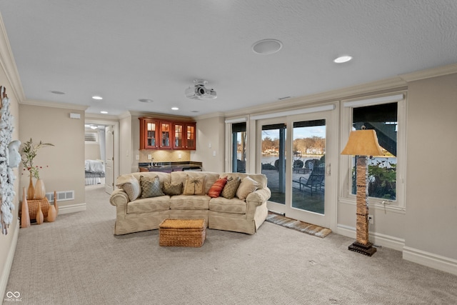 carpeted living room featuring indoor bar and ornamental molding