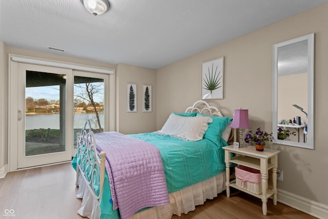 bedroom featuring access to outside and light hardwood / wood-style flooring