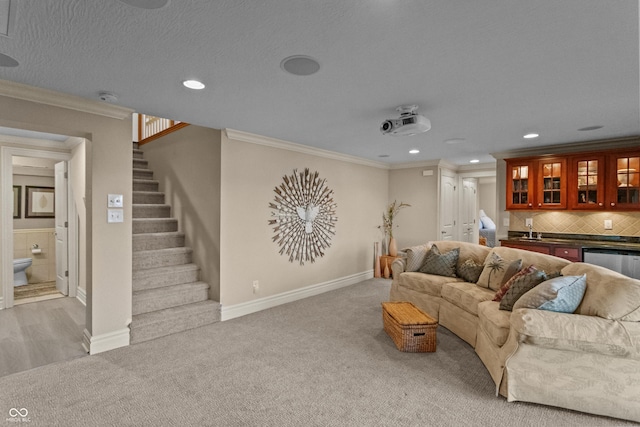 living room with light colored carpet, crown molding, and indoor wet bar