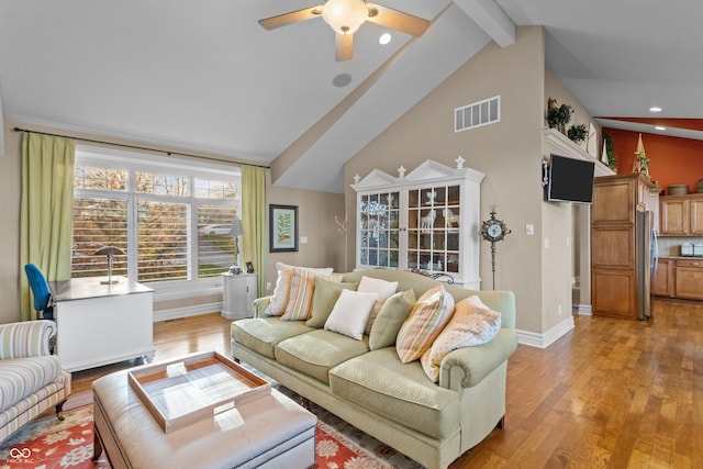 living room with lofted ceiling with beams, light hardwood / wood-style floors, and ceiling fan