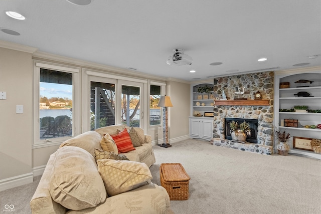 carpeted living room with crown molding, a fireplace, and built in features