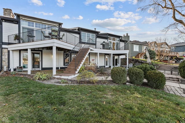 view of front of property with a balcony and a front yard