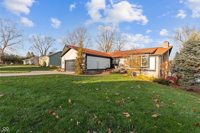 ranch-style house featuring a front yard and a garage