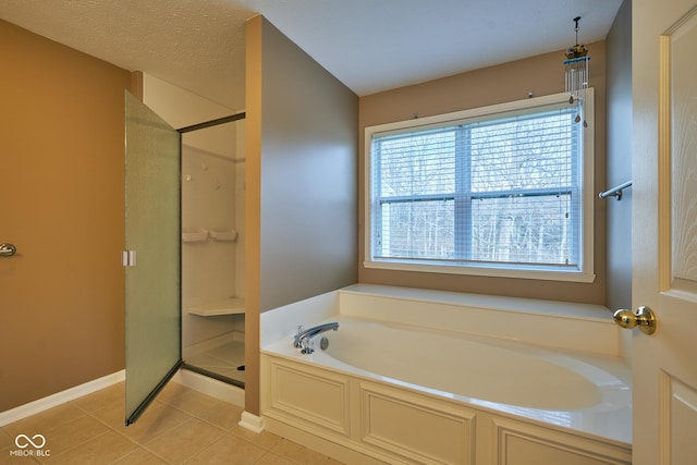 bathroom with shower with separate bathtub, a textured ceiling, and tile patterned floors