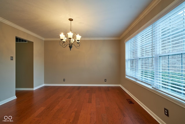 empty room with hardwood / wood-style floors, a notable chandelier, and crown molding