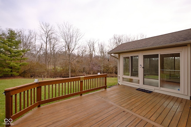 wooden terrace featuring a lawn